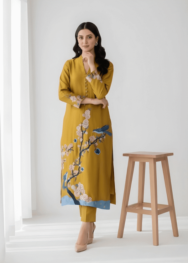 Close-up of resham thread embroidery on mustard sheesha silk formal suit