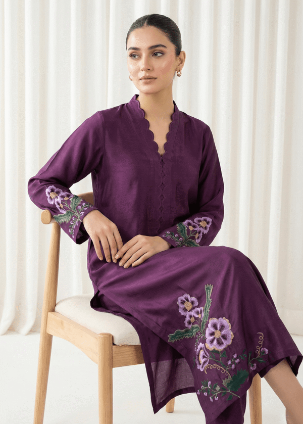 Close-up of resham hand embroidery bunches on plum purple formal suit